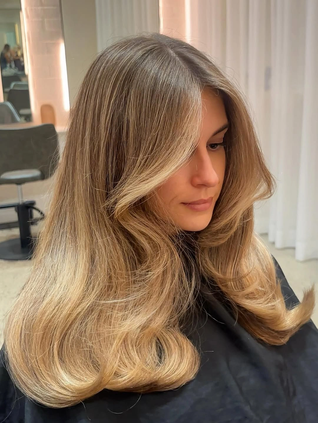 modern hair lowlights: color ideas and inspiration Honey Beige Lowlights with Soft Blowout Volume