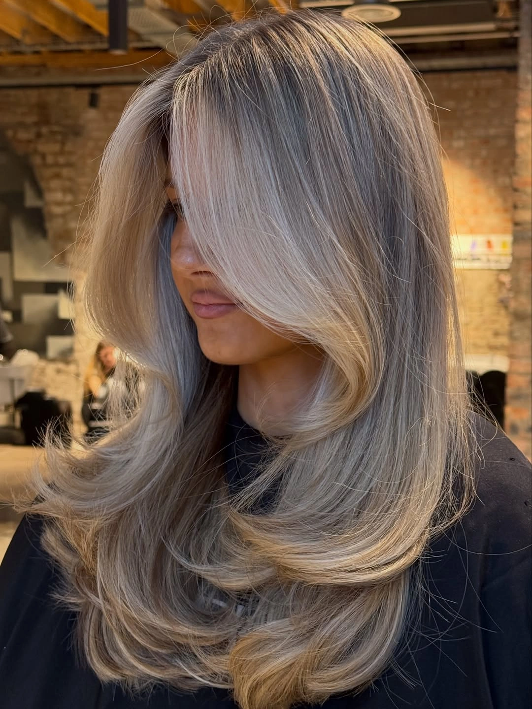modern hair lowlights: color ideas and inspiration Cool Champagne Blonde with Sculpted Layered Volume