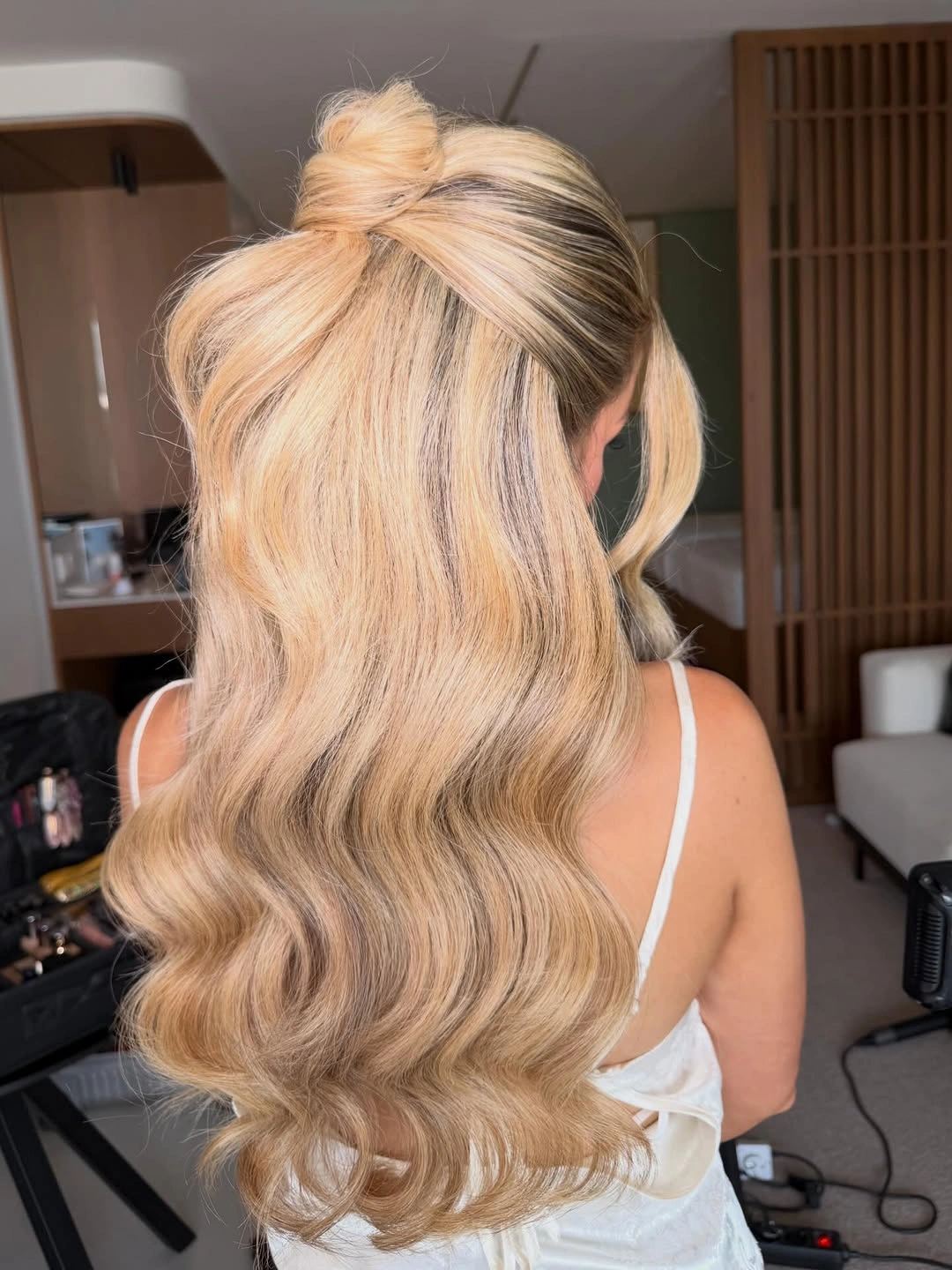 stylish bridesmaid hairstyling Soft Half-Up Waves with a Statement Bow Twist