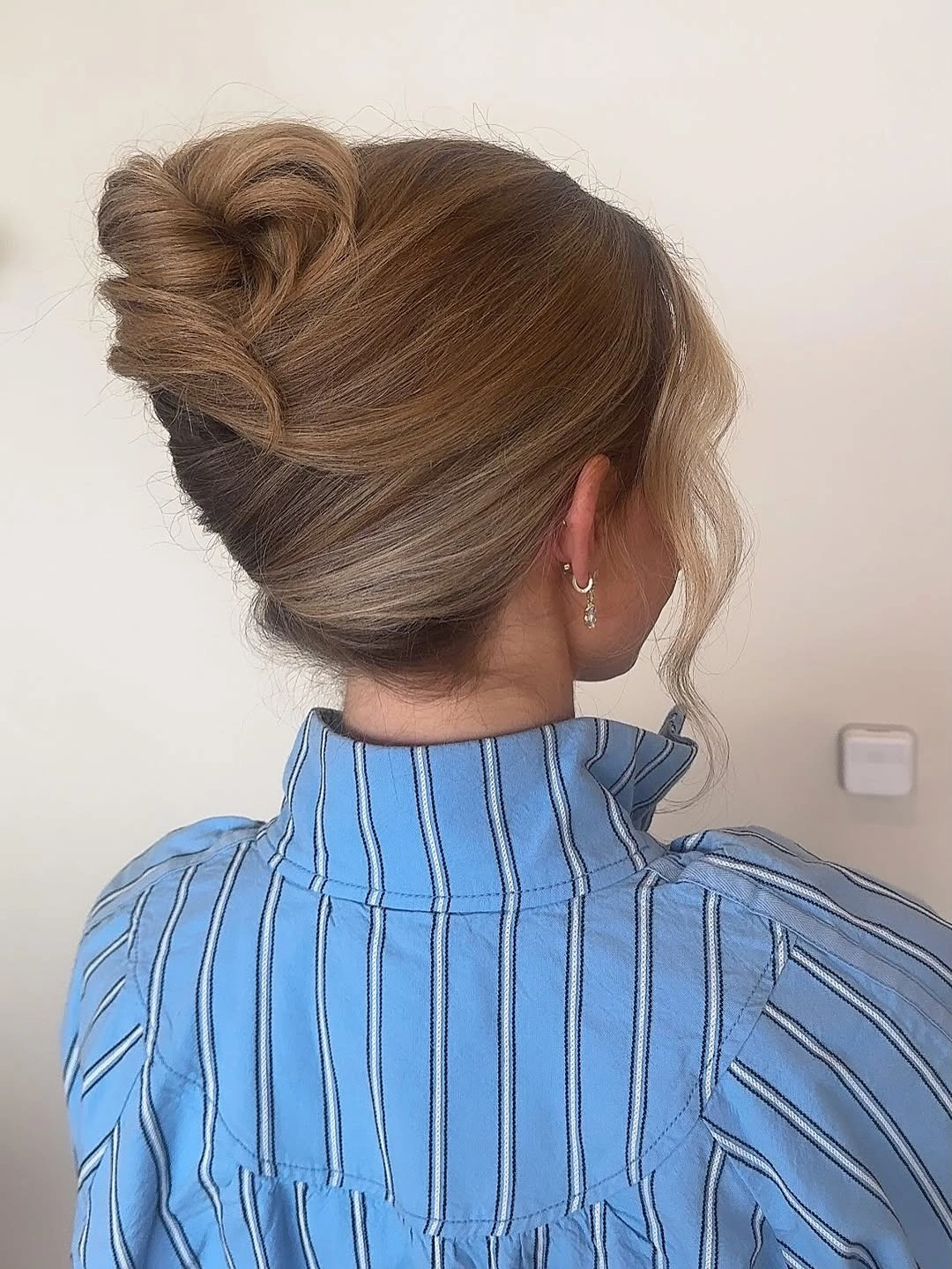 stylish bridesmaid hairstyling Soft Volume Bun with Face Framing Layers