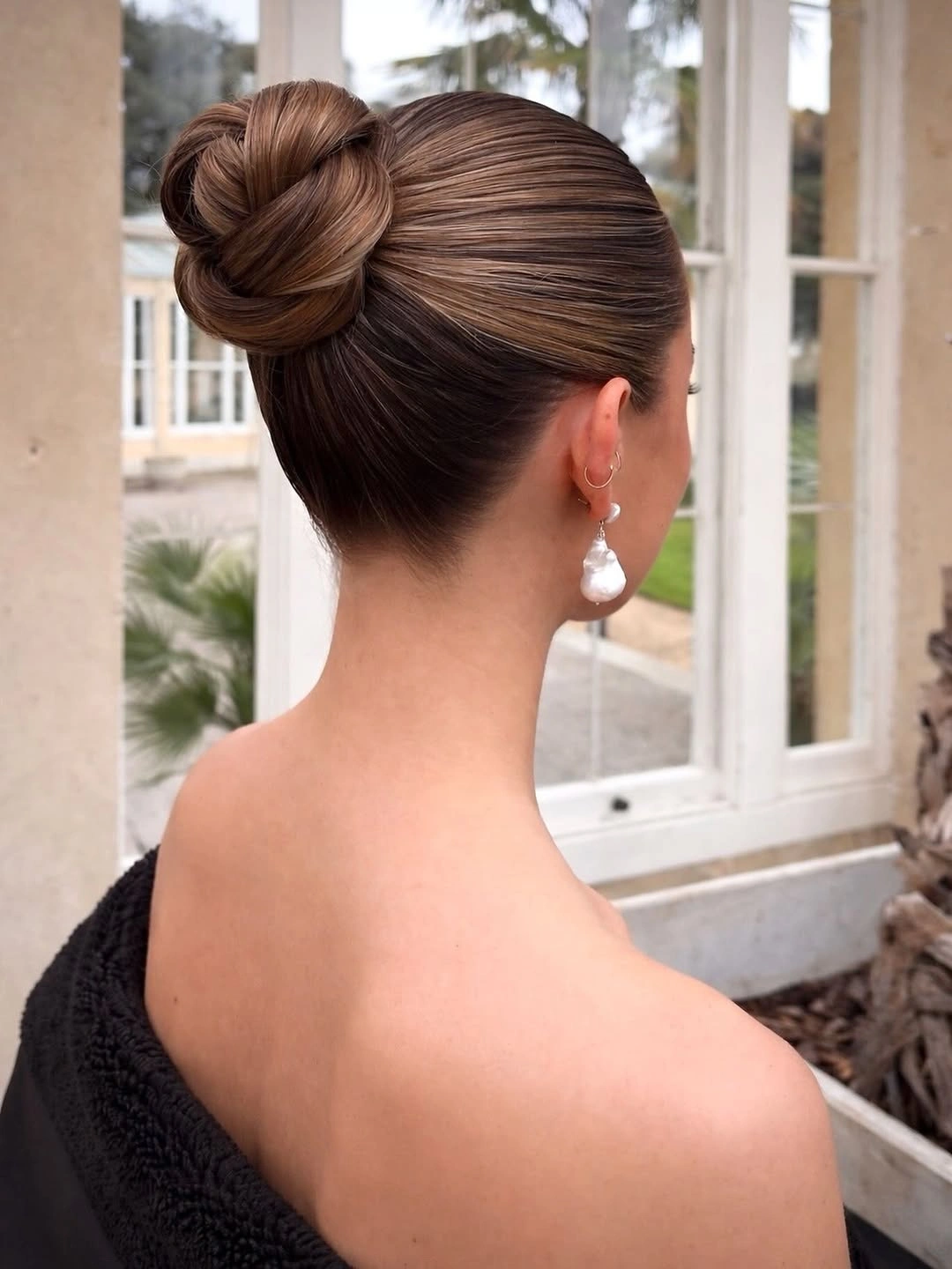stylish bridesmaid hairstyling Elegant Sculpted Bun for a Timeless Celebration