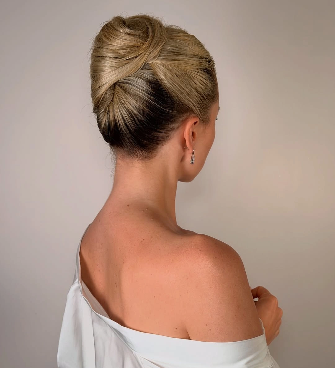 stylish bridesmaid hairstyling Modern Twisted Updo with Sculptural Volume