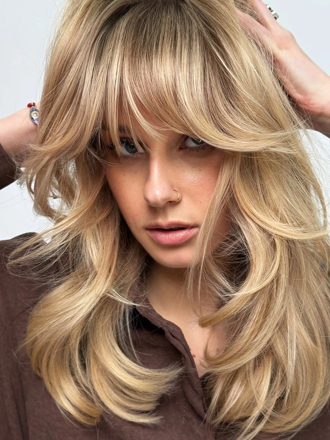 stylish choppy medium layered hair Voluminous Champagne Layers with Sweeping Bangs