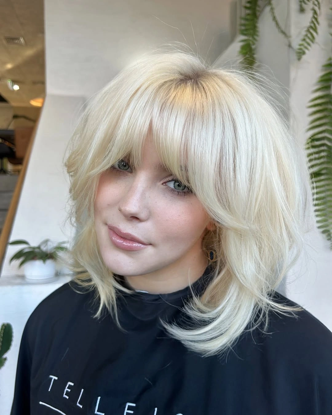 stylish choppy medium layered hair Playful Platinum Layers With Wispy Fringe