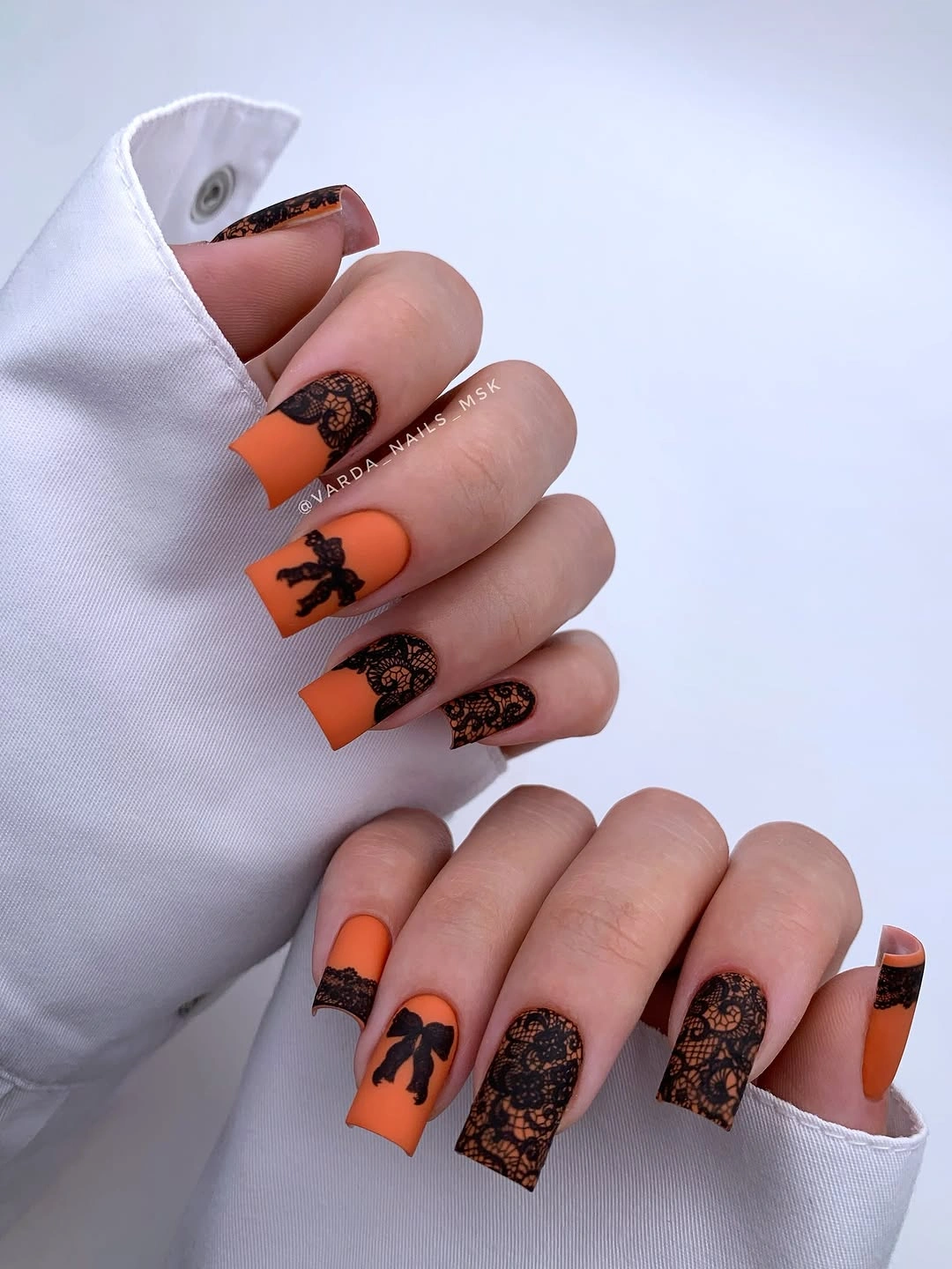 stylish fall nail art 2026 Matte Pumpkin and Black Lace Elegance