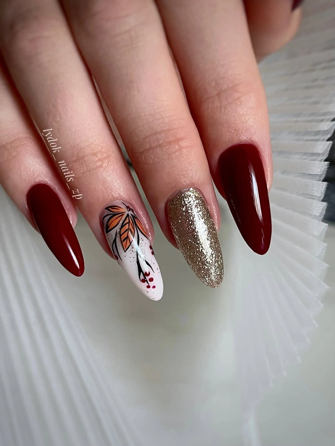 stylish fall nail art 2026 Deep Red Nails with Glitter Accent