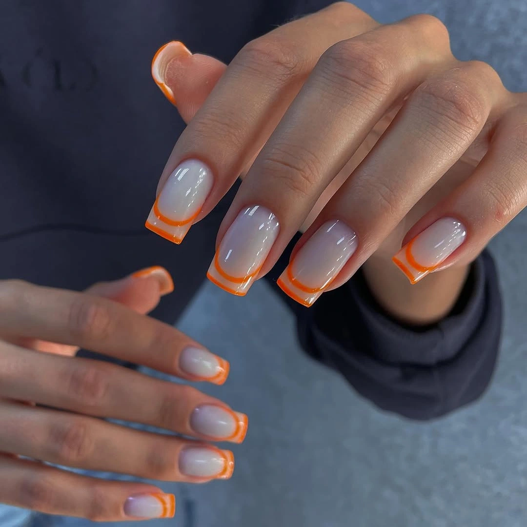 beautiful early fall nails 2026 sheer white nails with orange French edge