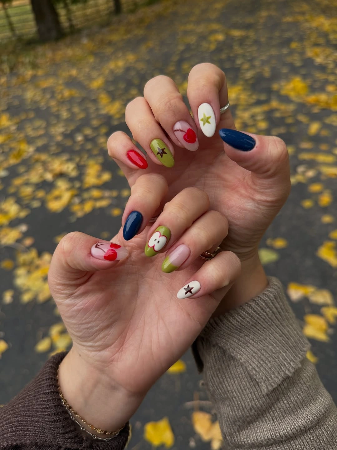 beautiful fall manicure ideas 2026 Playful Autumn Colors with Cherries and Apple Accents