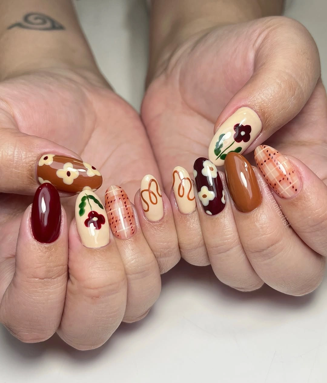 beautiful fall manicure ideas 2026 Warm Floral Brown Nails with Vintage Autumn Charm