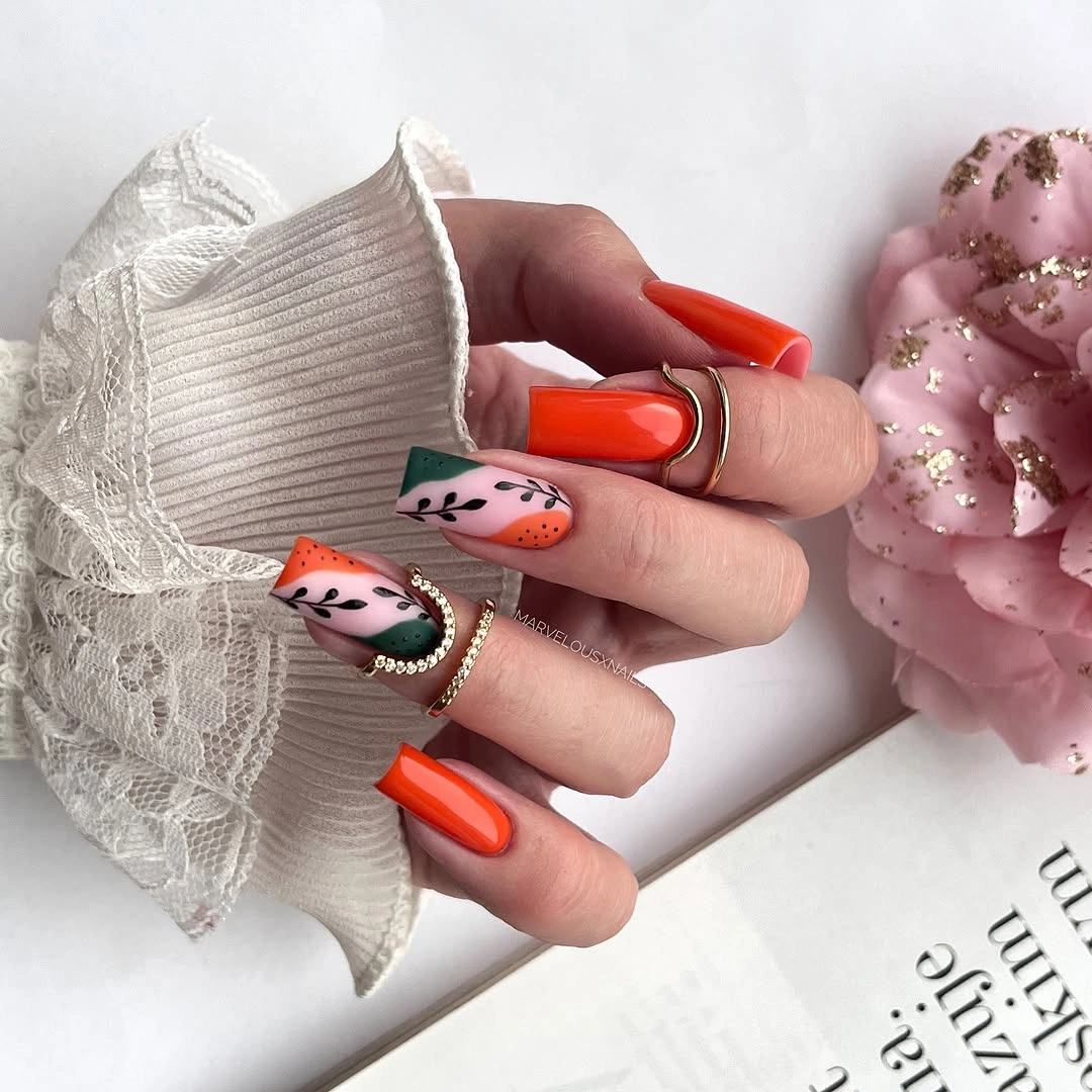 beautiful fall manicure ideas 2026 Bright Orange Nails with Modern Botanical Art
