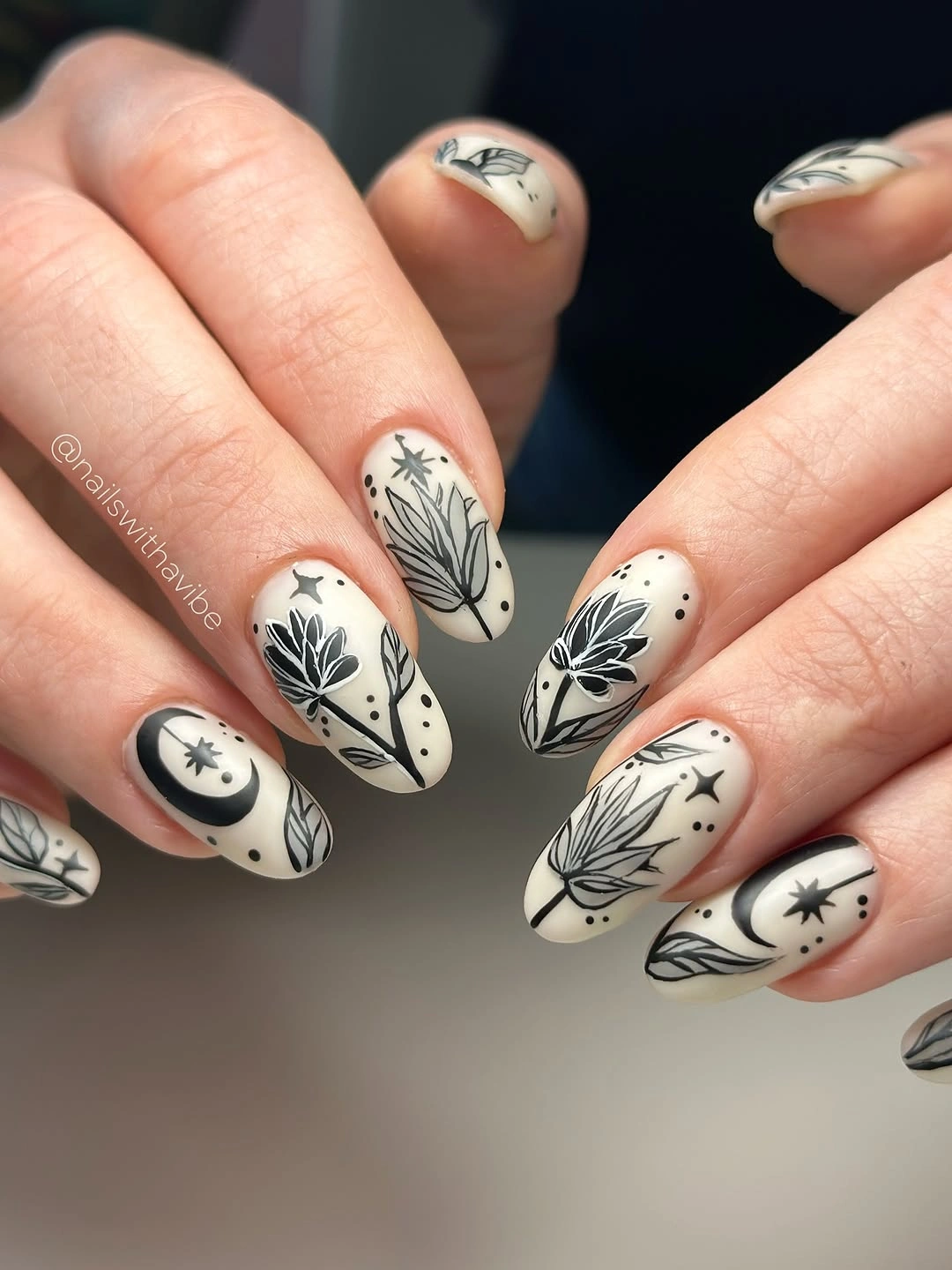 beautiful fall nail art ideas 2026 Black and Cream Botanical Nails for an Artsy Fall Mood