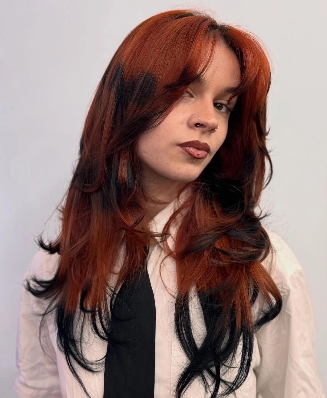 beautiful september hair colour trends 2026 Copper Red With Dramatic Black Underlayers