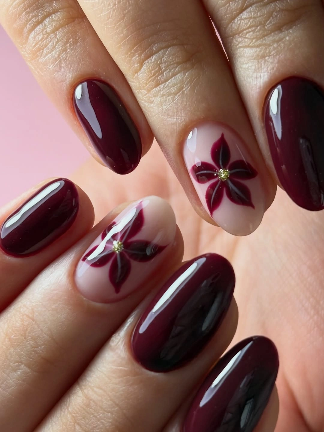 chic fall burgundy nails with design - Glossy Burgundy Floral Nails With a Soft Romantic Finish