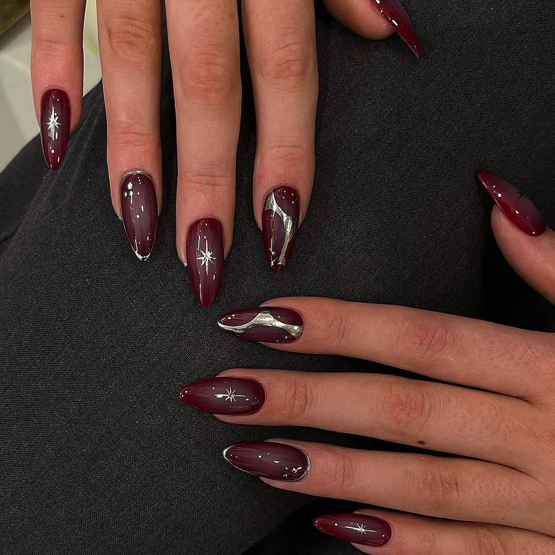 chic fall burgundy nails with design Burgundy Almond Nails With Silver Chrome and Starbursts