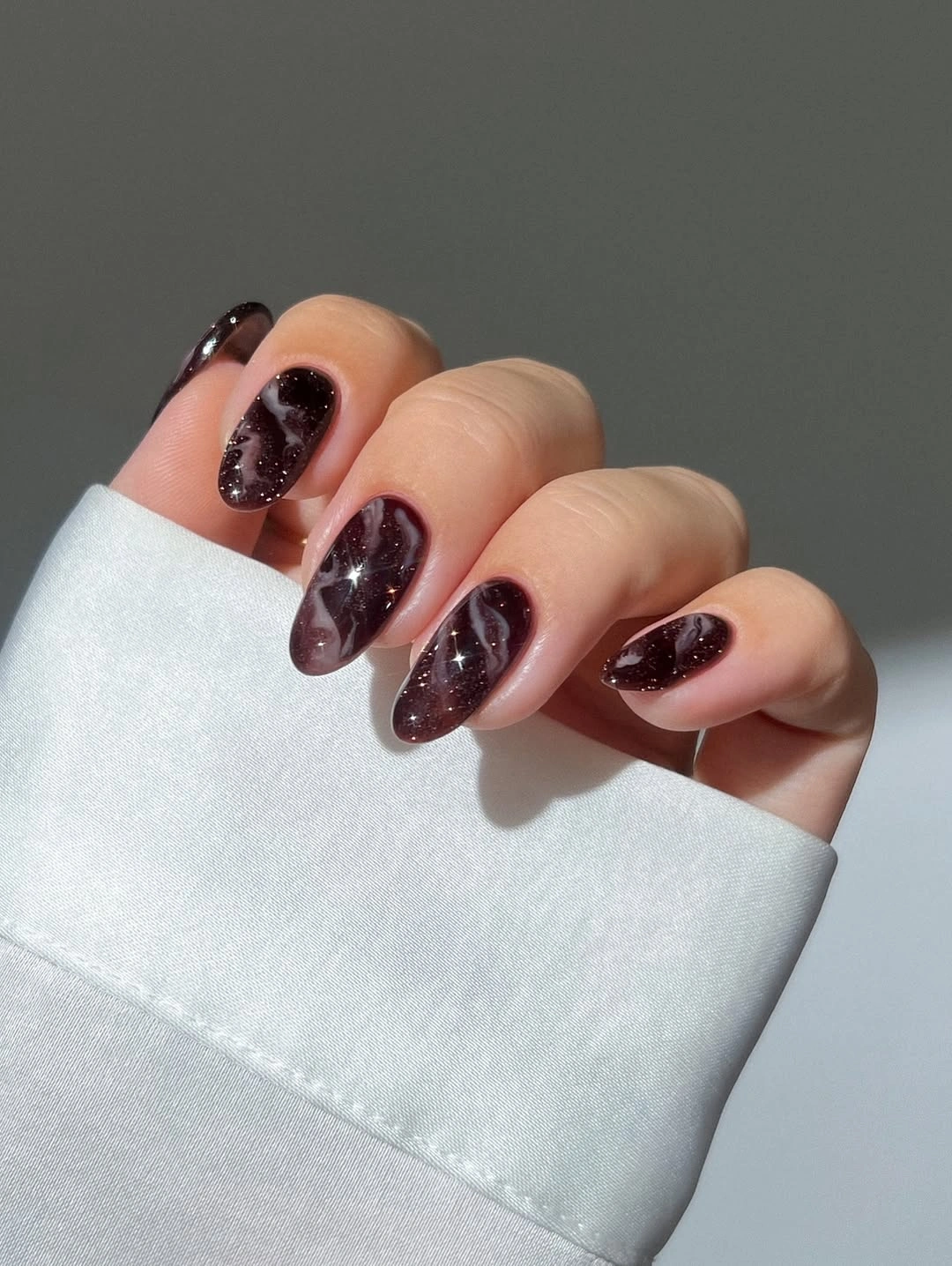 chic fall dark nail shadow ideas 2026 - Dark Plum Stardust Almond Nails