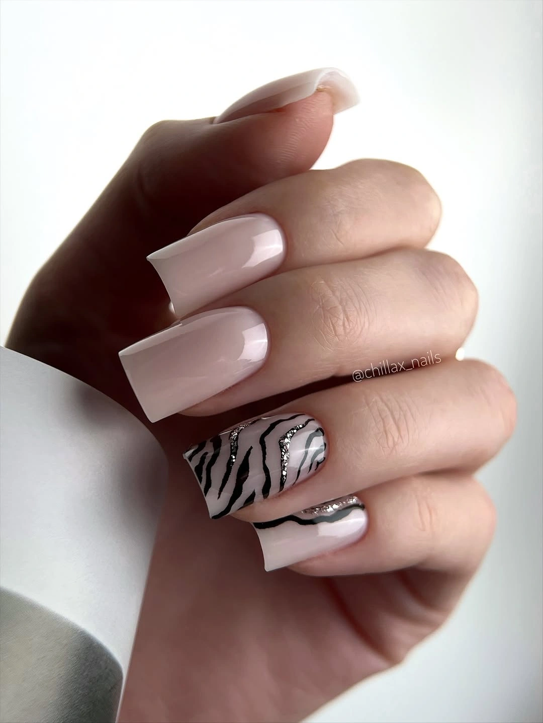 chic fall gel nails ideas 2026 - Milky White Zebra Nails With a Chrome Accent