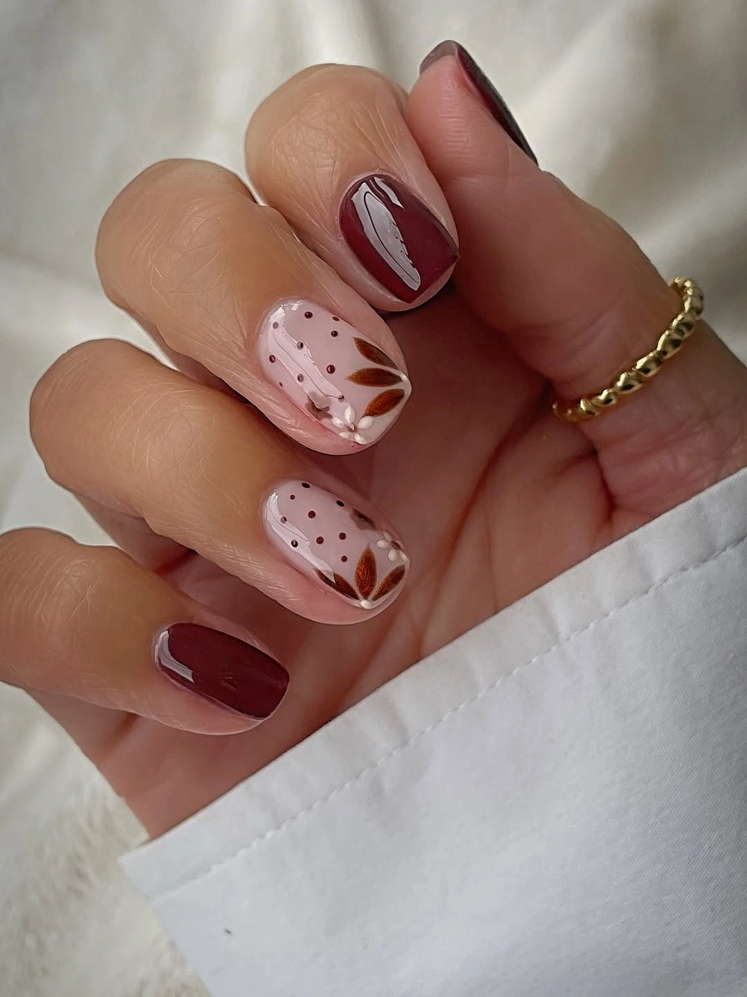 chic fall nail designs for all skin tones 2026 Burgundy Florals With Delicate Botanical Details
