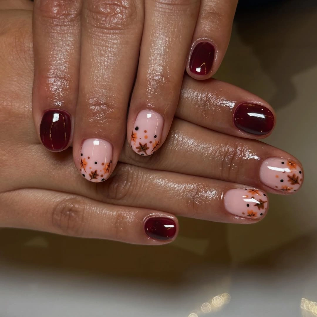 chic fall nail designs for all skin tones 2026 Minimal Burgundy And Autumn Leaf Short Nails