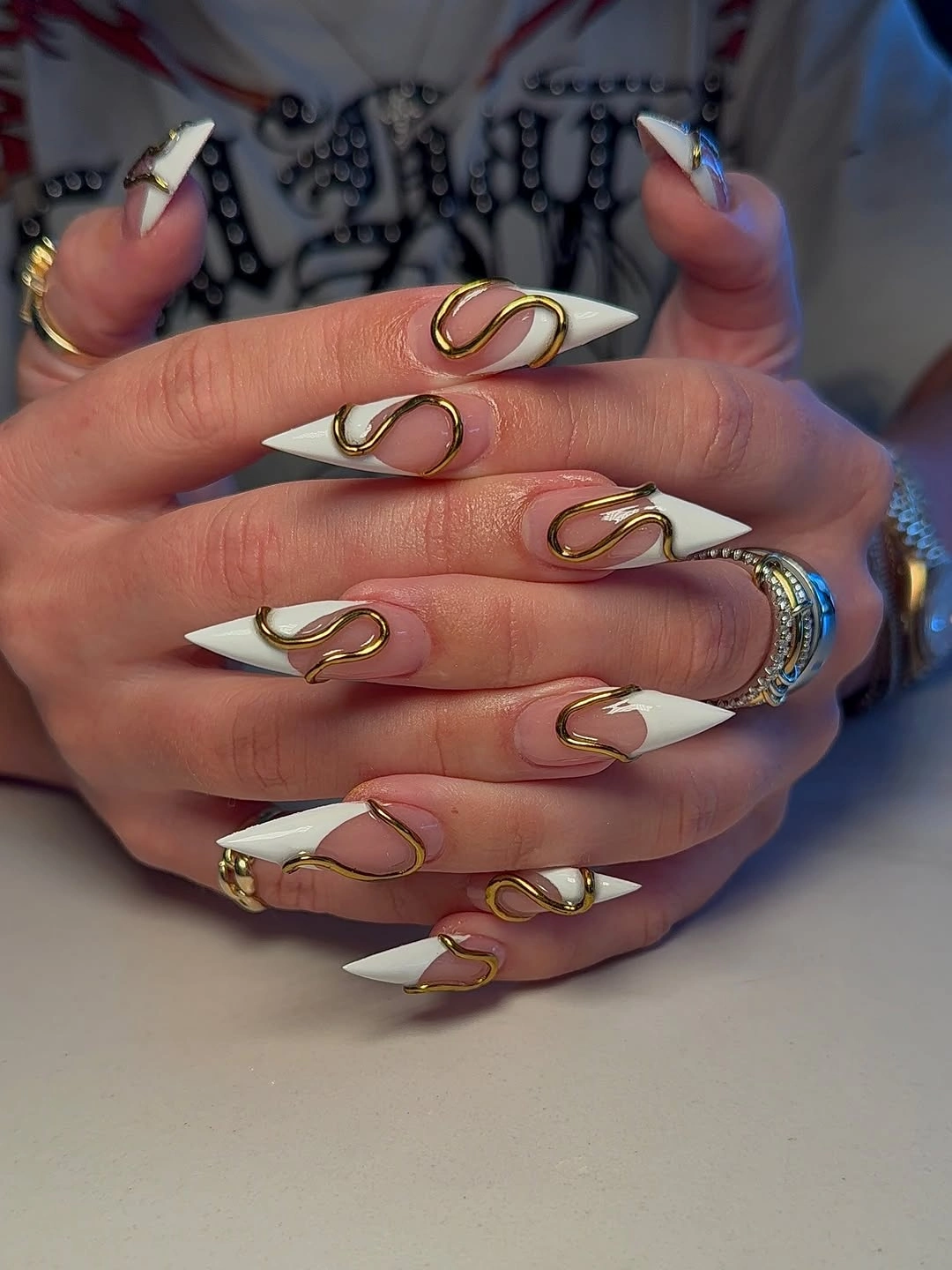 chic fall trendy nails 2026 White Sculptural Tips With Gold Swoops