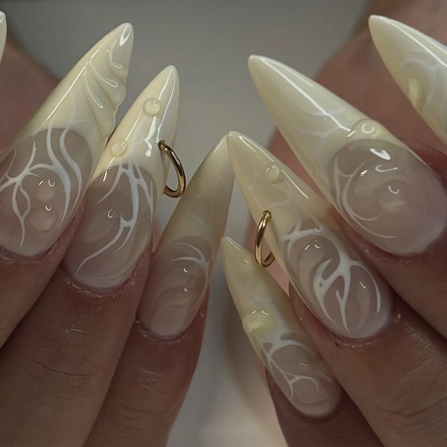 chic fall trendy nails 2026 Milky Almond Nails With Delicate White Swirls