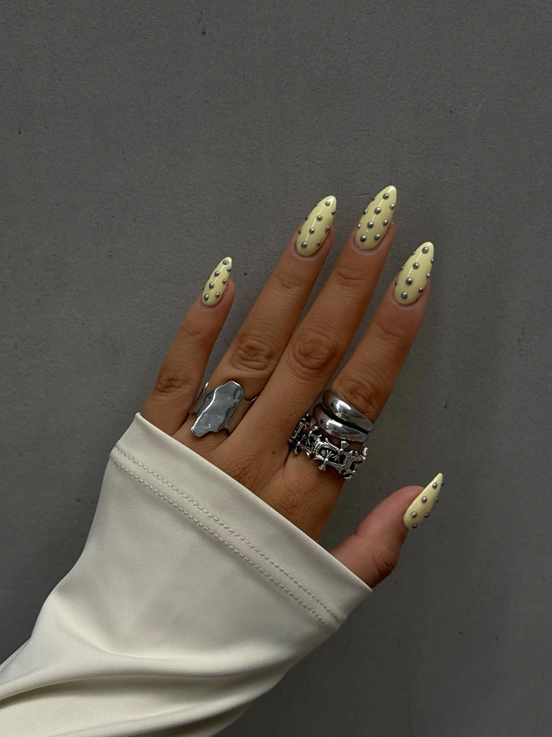 chic polka dot fall nails 2026 olive green nails with silver dots