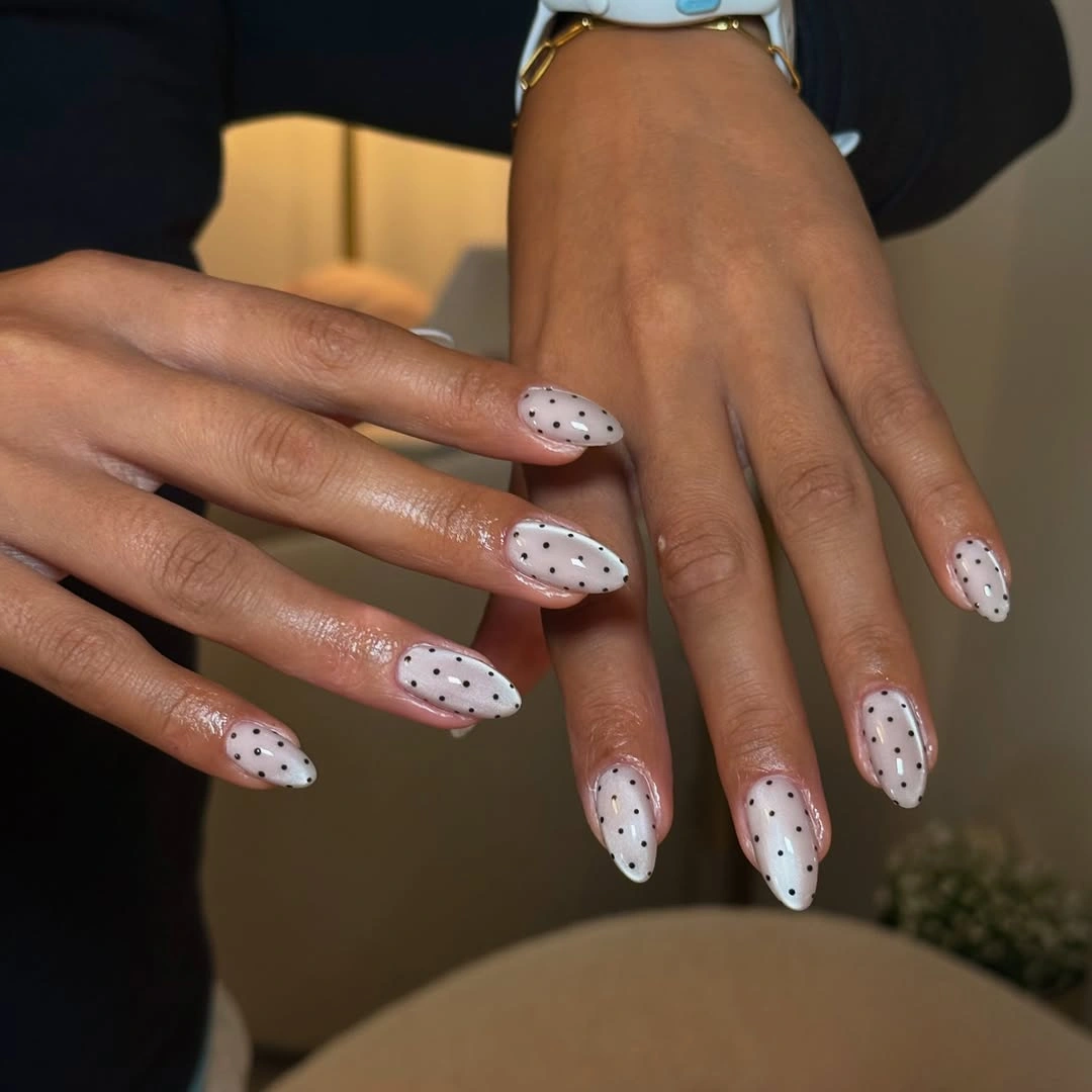 chic polka dot fall nails 2026 milky white almond nails with black dots