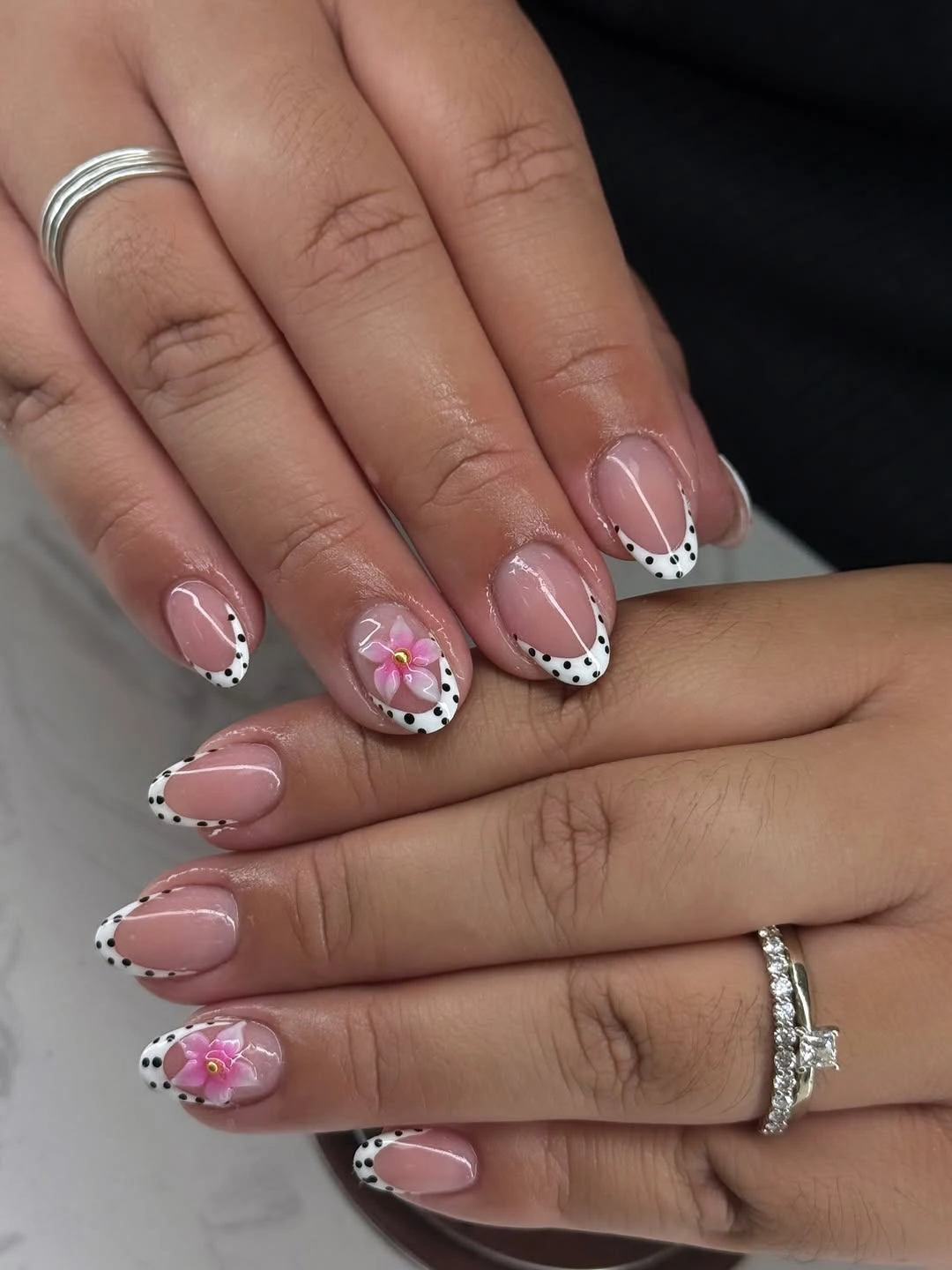 elegant fall short almond nails 2026 Playful Polka Dot French with Soft Floral Accent