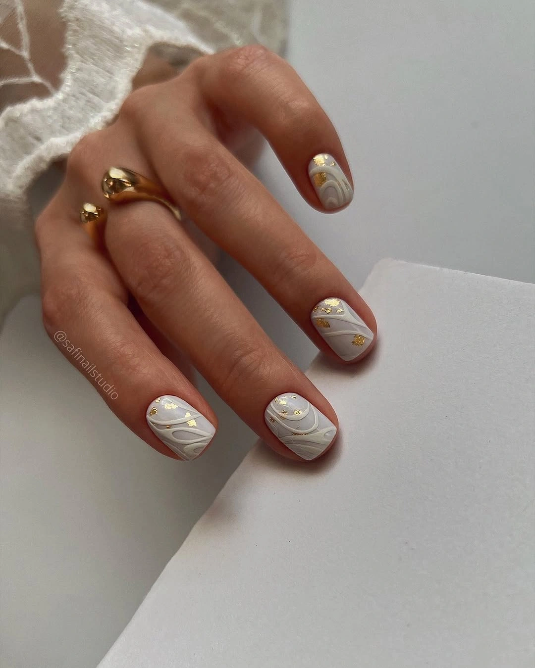 Elegant nude fall nails 2026 with ivory marble and gold foil