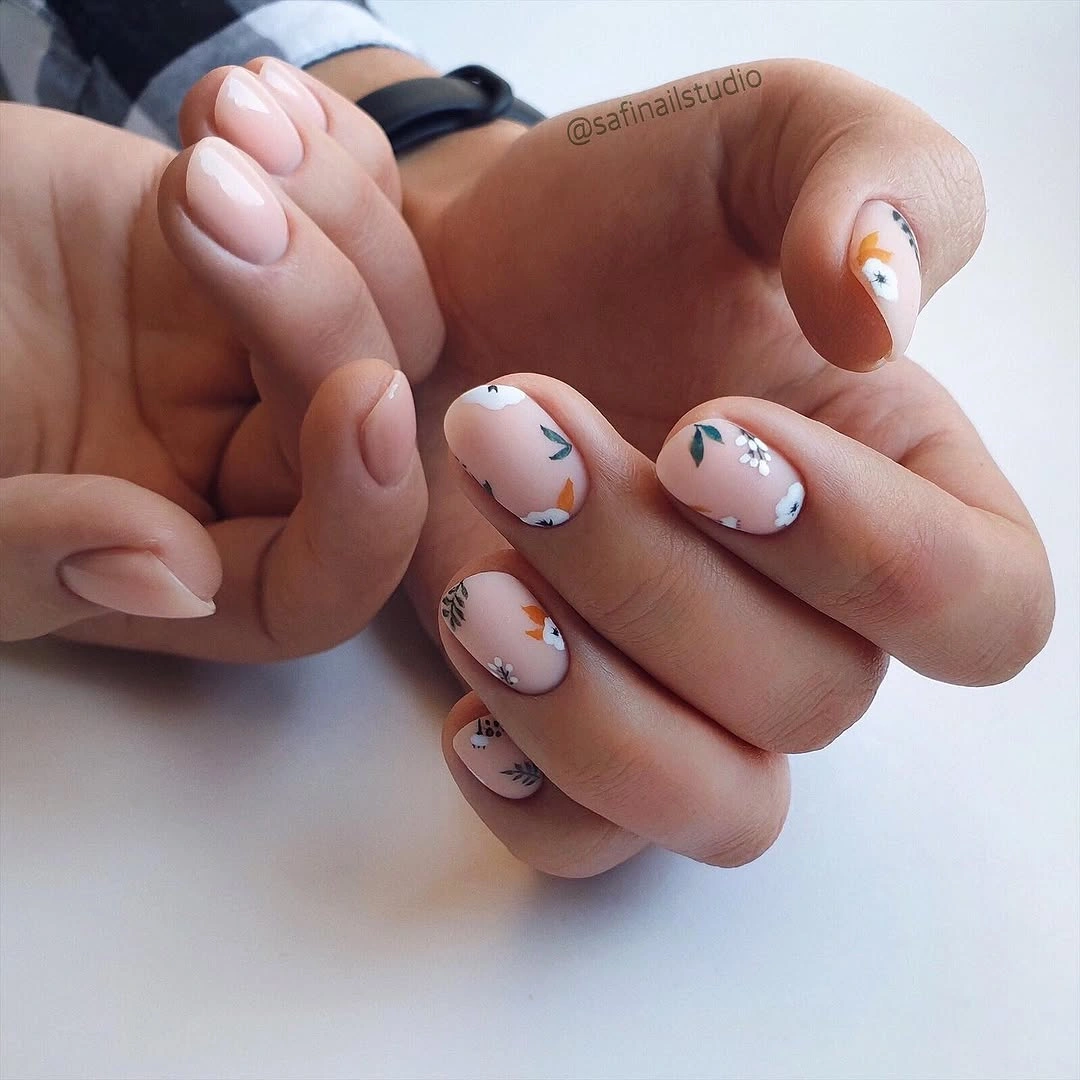 Elegant nude fall nails 2026 with delicate floral nude manicure