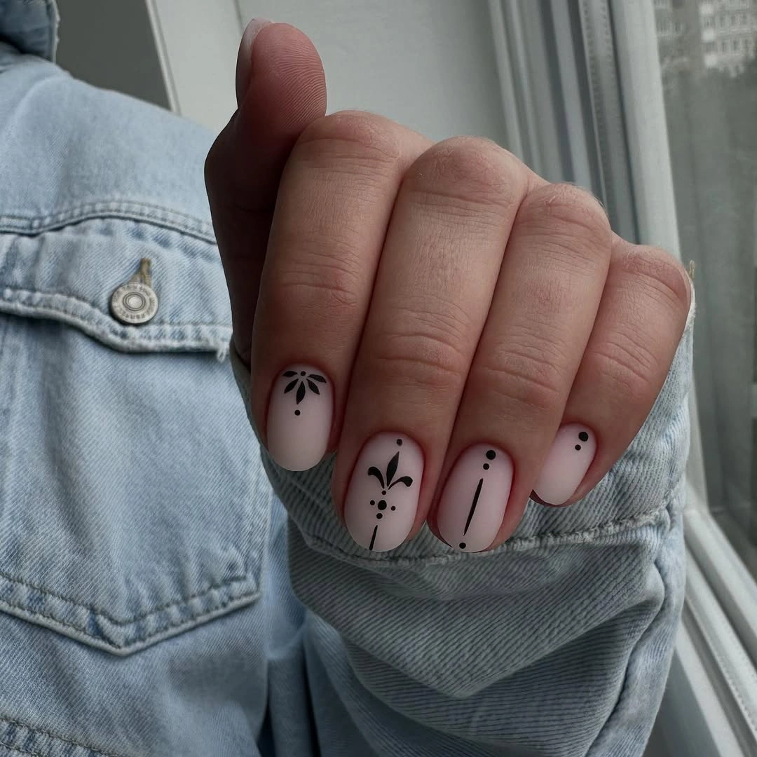 Elegant nude fall nails 2026 with minimal black nail art