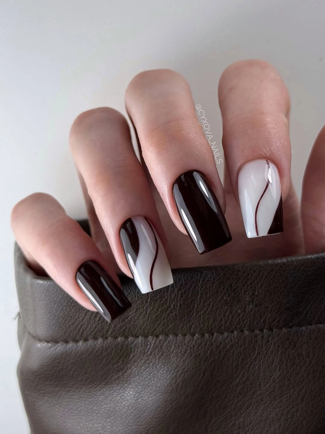 gorgeous dark fall nails 2026 - Black and White Waves With a Burgundy Accent