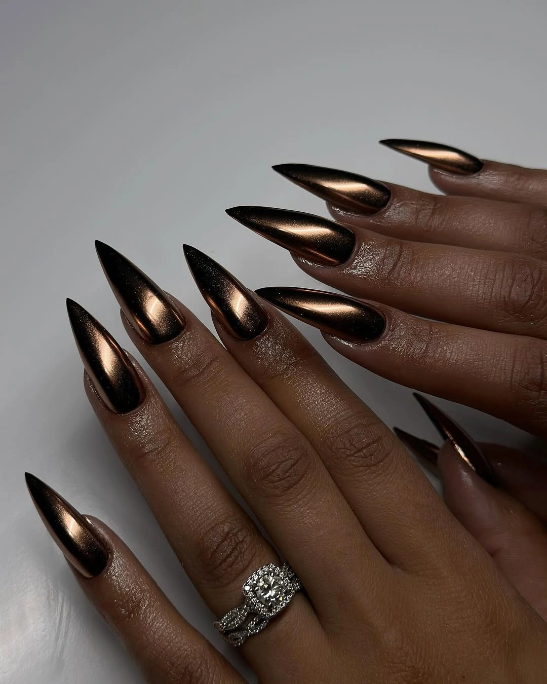 rich fall nails colors for dark skin Bronzed Chrome Stiletto Nails for Deep Autumn Glamour