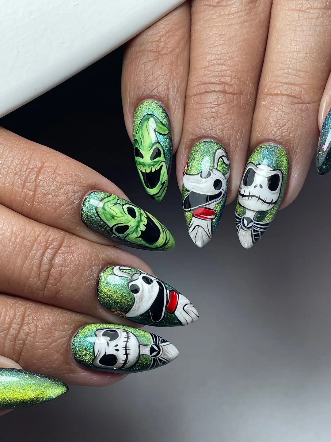 spooky halloween nails designs 2026 green glitter Frankenstein and Jack Skellington almond manicure