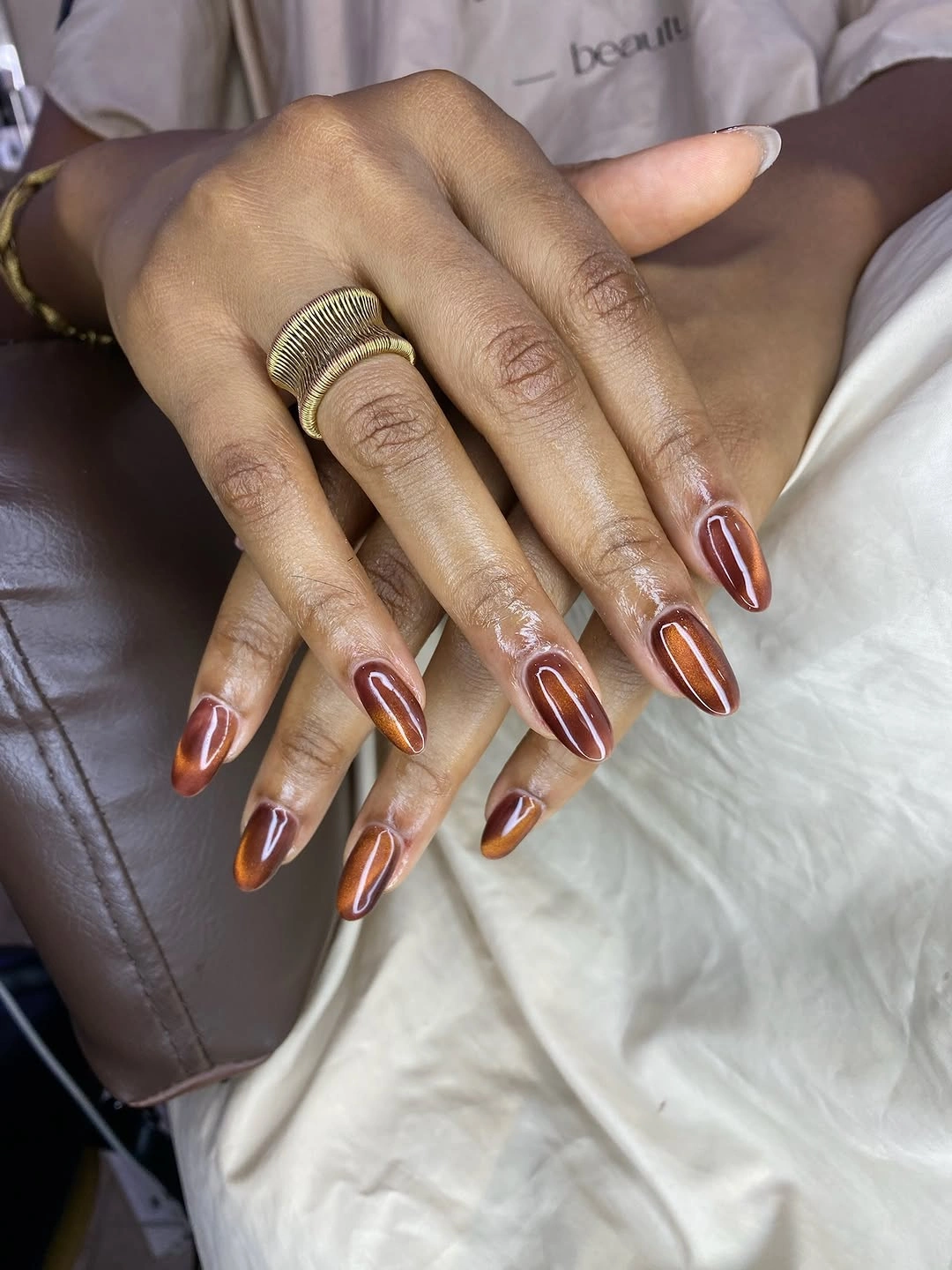 stunning fall nails for dark skin 2026 Cinnamon Cat Eye Almond Nails