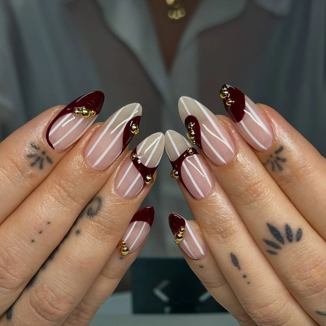 Stylish Fall Nail Trends 2026 Deep Red French Tips With Gold Details That Feel Instantly Elegant