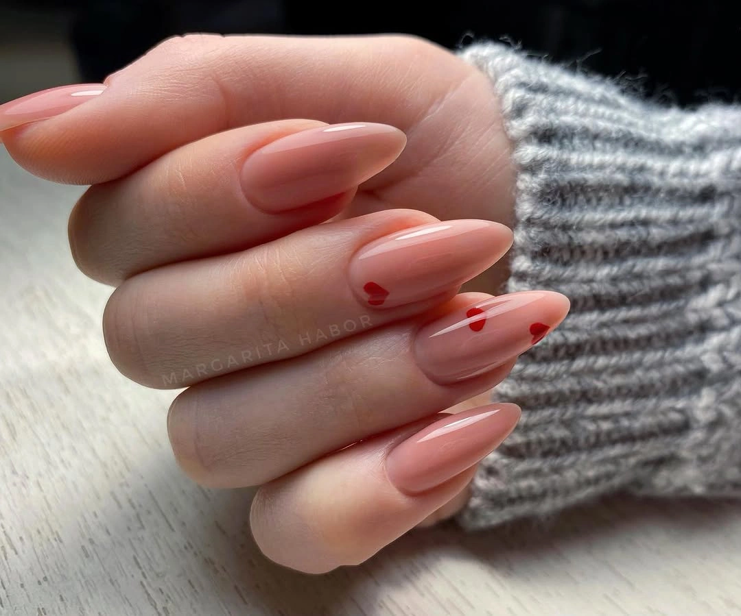 stylish fall nails for fair skin tones 2026 Delicate Red Hearts on Blush Almond Nails