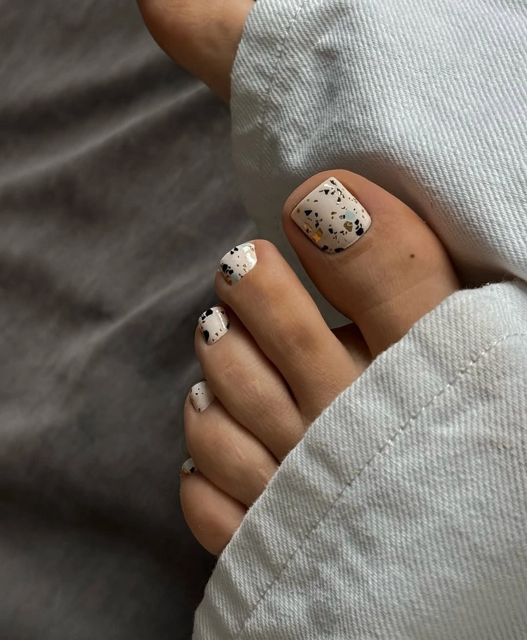 stylish fall toe nails colors 2026 - Speckled Cream Pedicure With Autumn Flecks