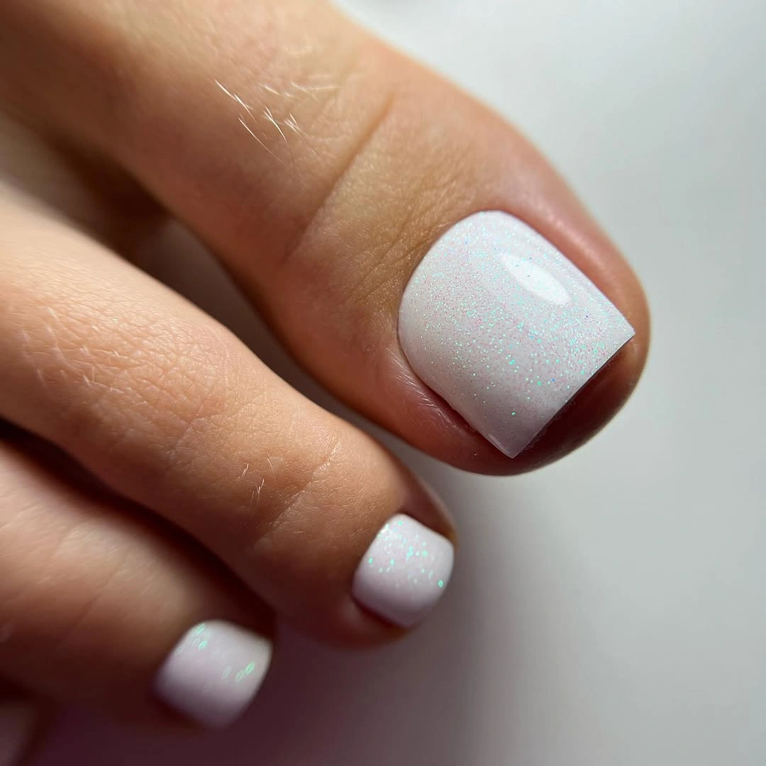 stylish fall toe nails colors 2026 - White Pedicure With Icy Iridescent Shimmer