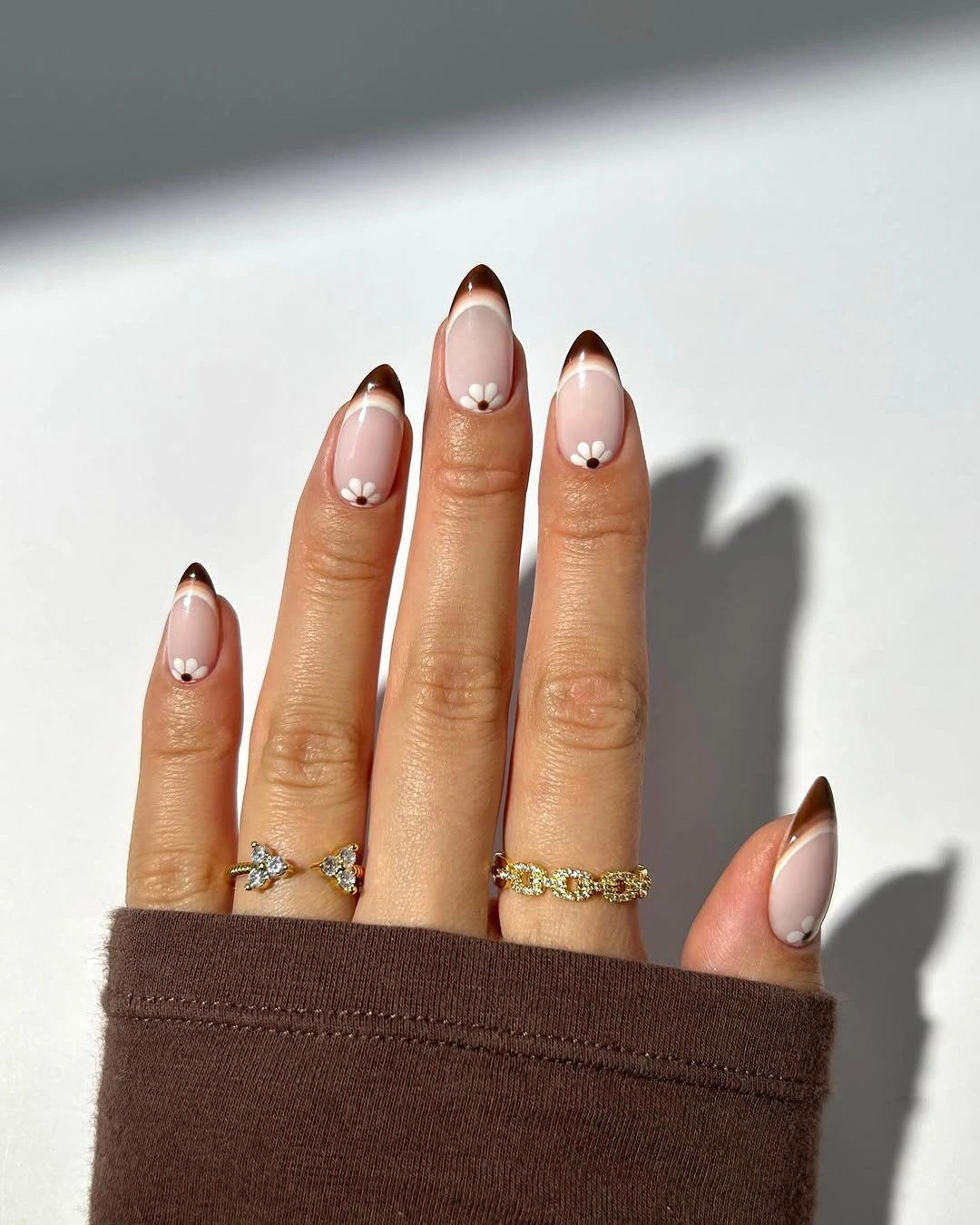 trendy brown fall nails 2026 Light Brown French Tips With Tiny Daisy Details