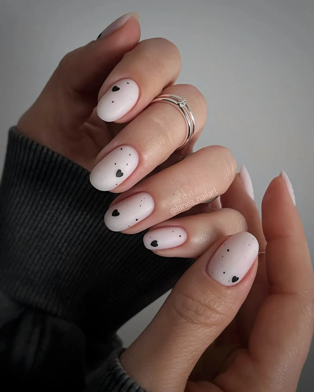 trendy matte fall nails design 2026 Soft White Nails With Tiny Black Hearts