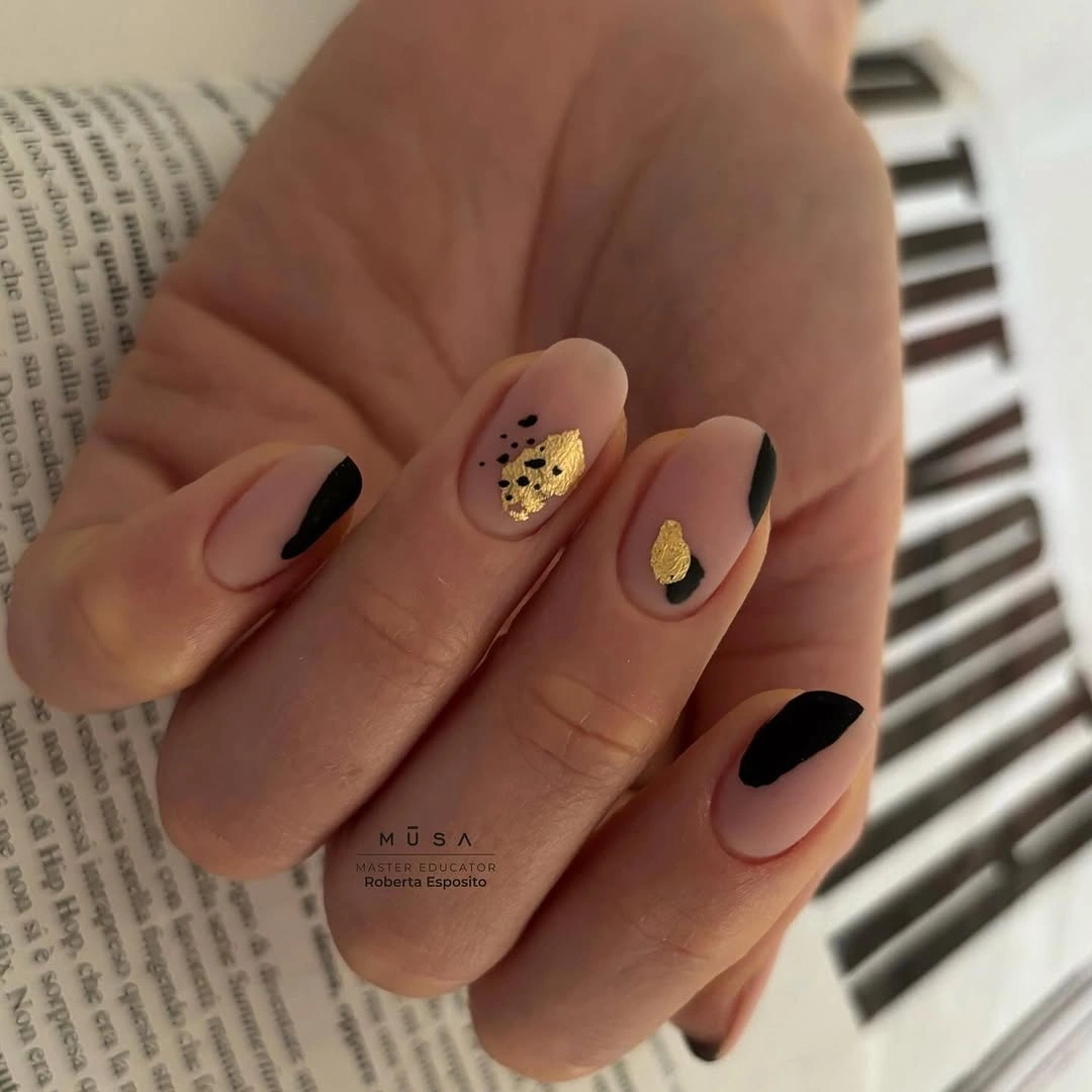 trendy matte fall nails design 2026 Nude Nails With Black and Gold Abstract Art