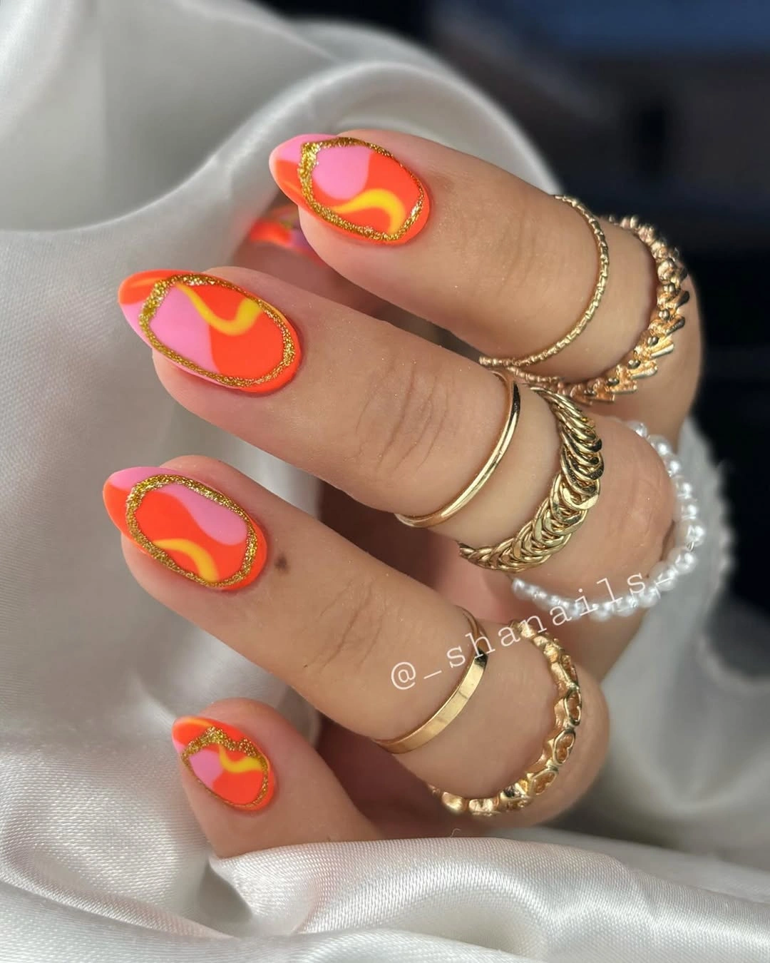trendy matte fall nails design 2026 Warm Orange and Pink Nails With Gold Framed Details
