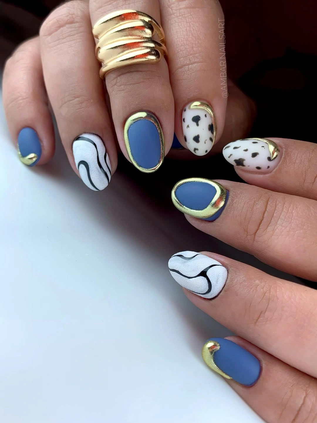 trendy matte fall nails design 2026 Matte Blue Nails With Cow Print and Sculptural Lines