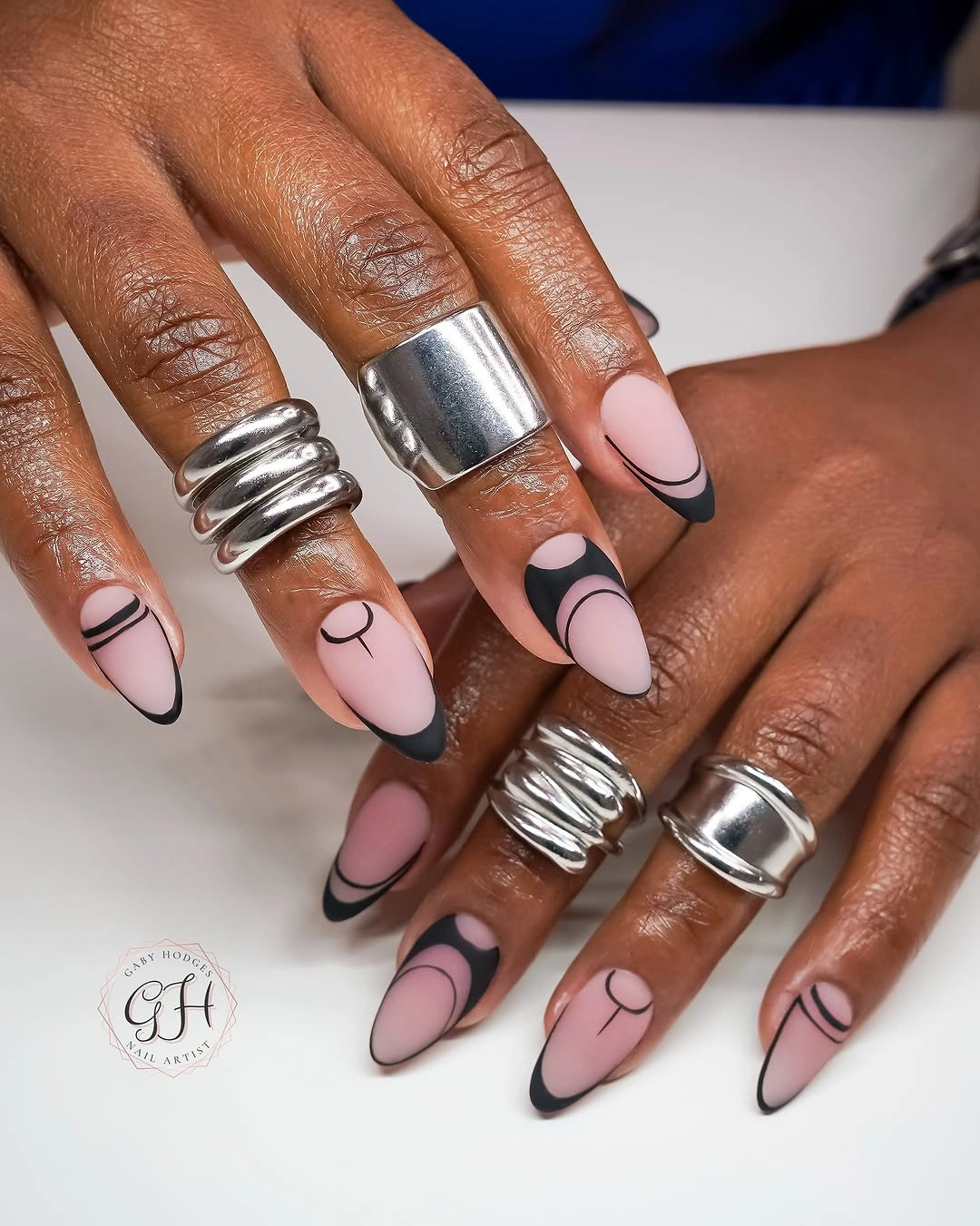 trendy matte fall nails design 2026 Soft Pink Almond Nails With Graphic Black Tips