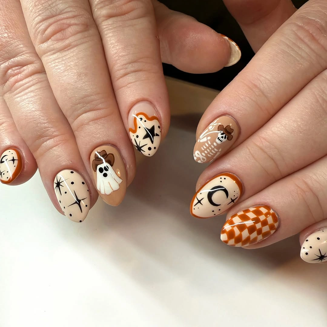 unique halloween nail art 2026 Subtle Ghost and Moon Manicure in Warm Autumn Neutrals
